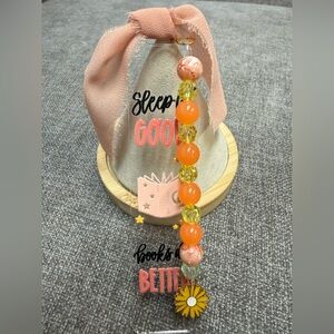 Acrylic bookmark with “Sleep is good, books are better ” design, and beads. NWOT